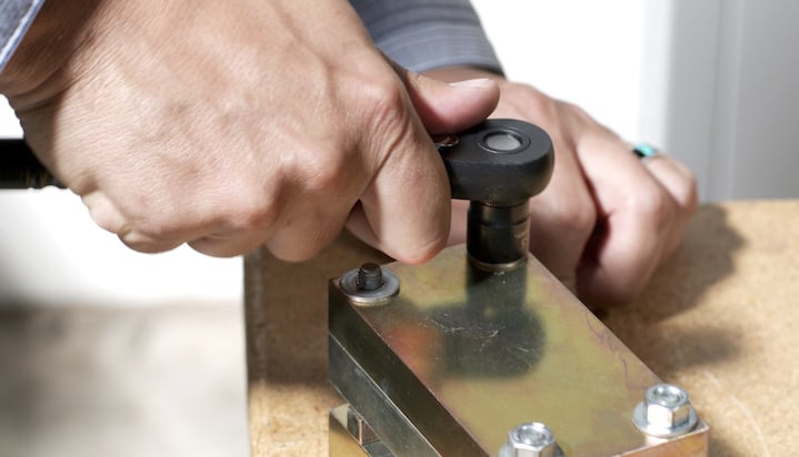 Employee tightening screws 